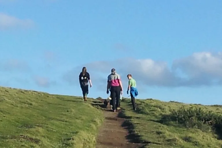 Family walking the Southwest Coastpath near Lower Campscott Farm,as part of an active holiday in North Devon