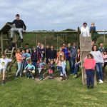 Family farm pictures next to the play equipment - a family staying in group accommodation at Lower Campscott Farm