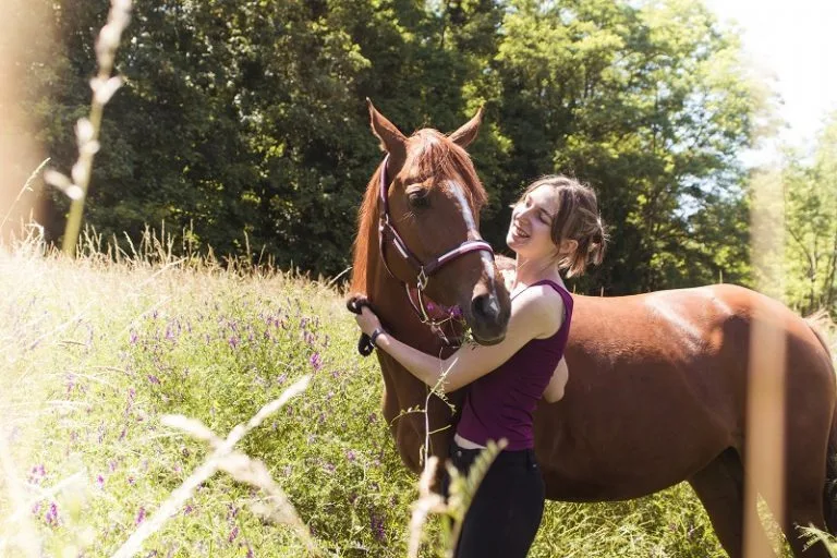 Woman tending to horse at Lower Campscott as part of an active holiday in North Devon