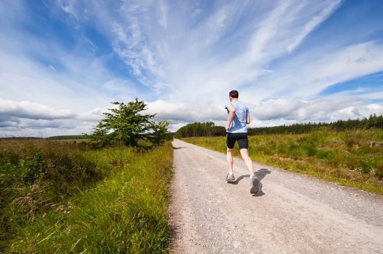 Man running on a footpath near Lower Campscott Farm as part of an active holiday in North Devon
